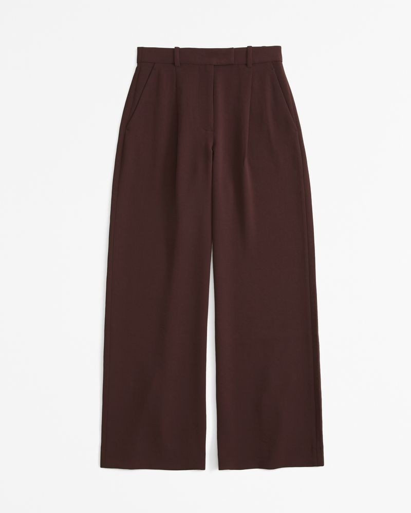 High-waisted trousers paired with a tucked-in shirt for petite men