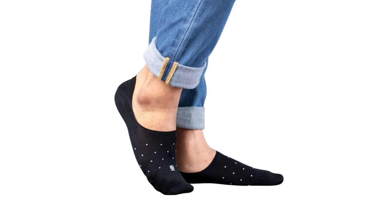 Man wearing grey suit with navy calf-length socks