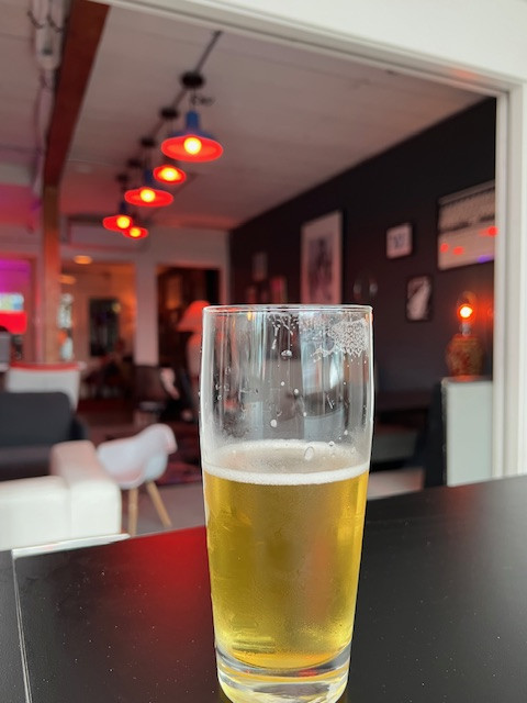 Man in denim jacket and graphic tee in a brewery