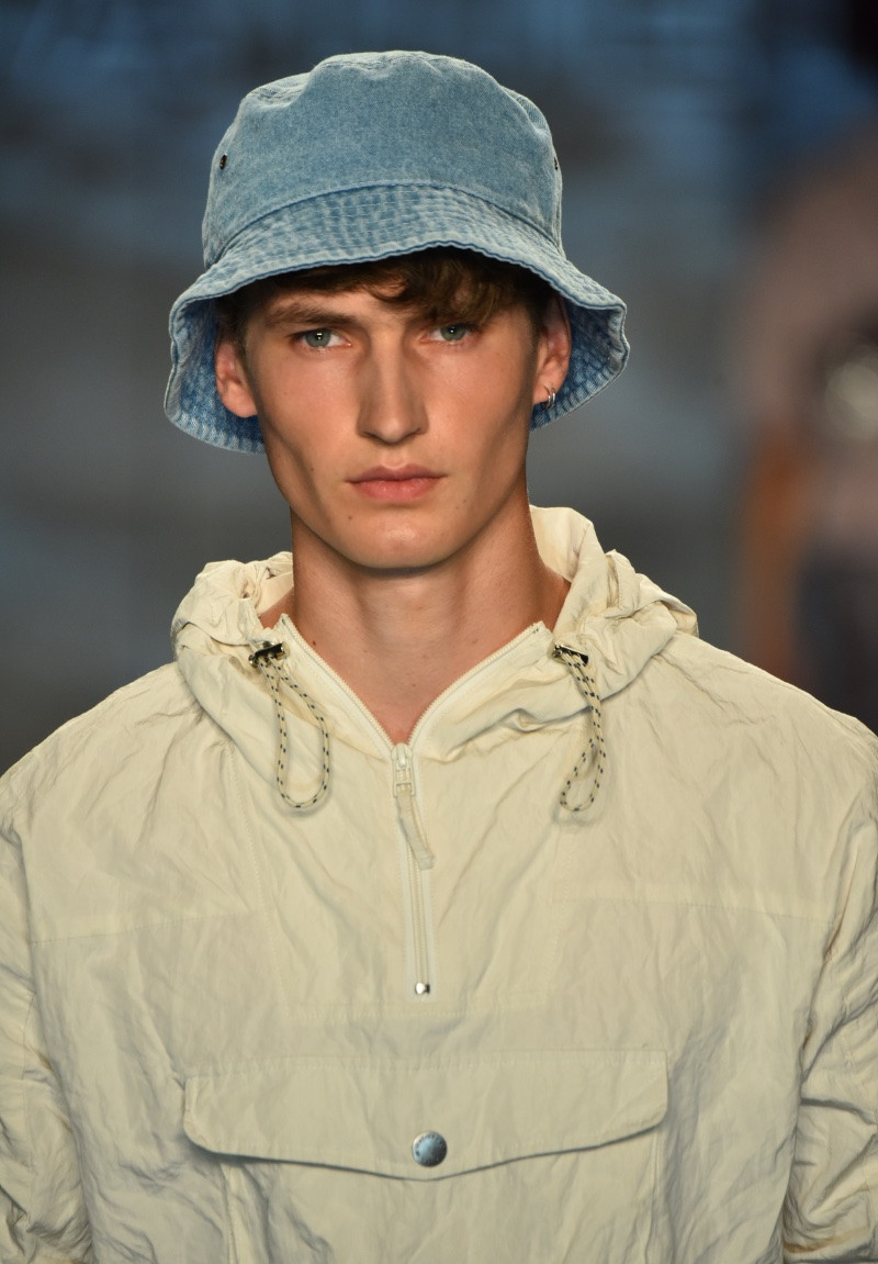 Man wearing a denim bucket hat, showcasing its versatility