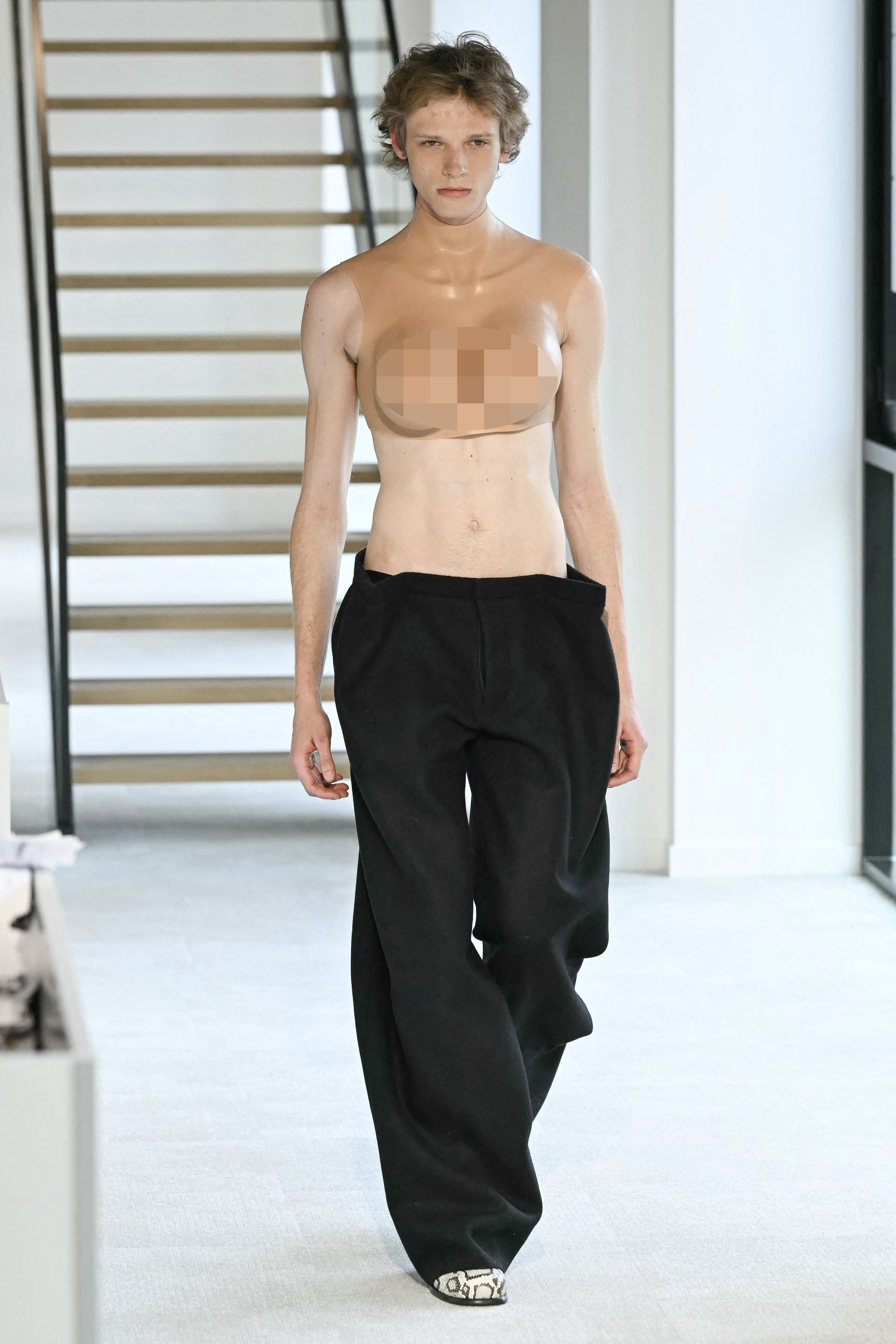 Male model Chandler Frye showcasing a daring topless look with confidence