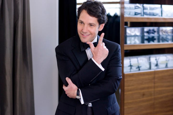 Man wearing a navy suit and white shirt