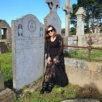 Man in black gothic romance outfit with silver pendant