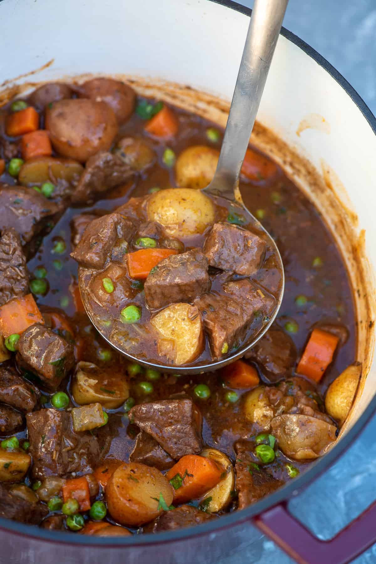 Seared beef cubes in a dutch oven, alt=Browning beef cubes in a Dutch oven for rich flavor.
