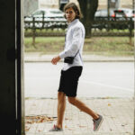 A pair of beige cargo shorts with multiple pockets, styled casually with a navy t-shirt