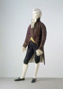 High-waisted coat and light-colored trousers reflecting early 1800s fashion