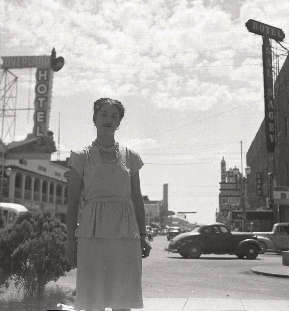 A man confidently sporting a well-tailored suit, vintage sunglasses, and a stylish fedora hat, embodying the essence of 1960s Vegas fashion with a modern twist.