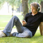 2000s Fashion Men Teen Polo Shirt Baggy Jeans Sneakers Listening to Music Park