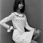 Model wearing a Mary Quant dress, 1964, England. The image captures the essence of the youthful and rebellious fashion trends of the era.