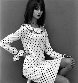 Model wearing a Mary Quant dress, 1964, England. The image captures the essence of the youthful and rebellious fashion trends of the era.