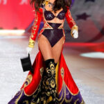 Adriana Lima bursts onto the runway with vigor at the Victoria's Secret Fashion Show 2012