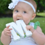 Adorable baby girl with wooden M