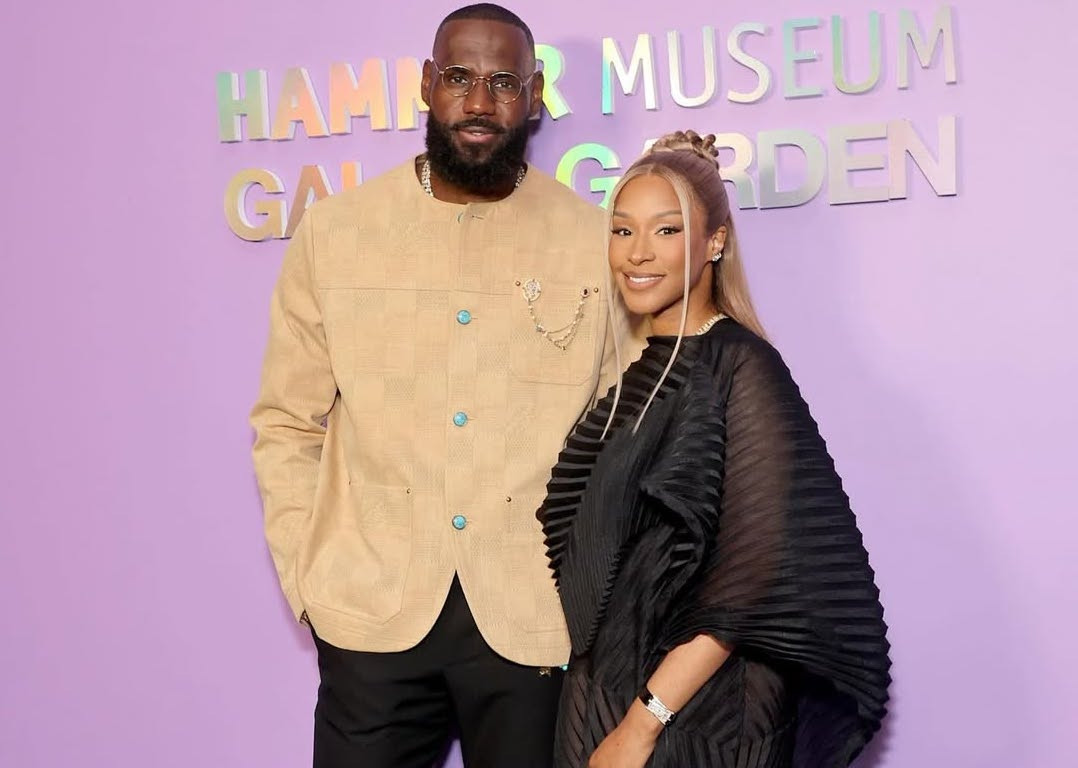 LeBron James at the Hammer Museum Gala, wearing a Louis Vuitton suit with Savannah James in Issey Miyake, displaying a sophisticated and coordinated look
