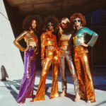 Woman in a shimmering sequin dress with flared sleeves, embodying the 70s disco fashion retro outfit style