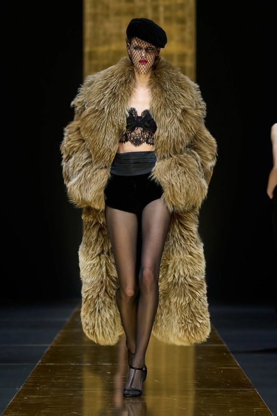 Dolce & Gabbana Fall 2024 Ready-to-Wear showcases a luxurious fur coat, embodying the trend of Texture Triumph with voluminous proportions and opulent design