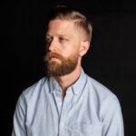 Blonde man with a blonde faded beard, exemplifying a modern and stylish appearance.
