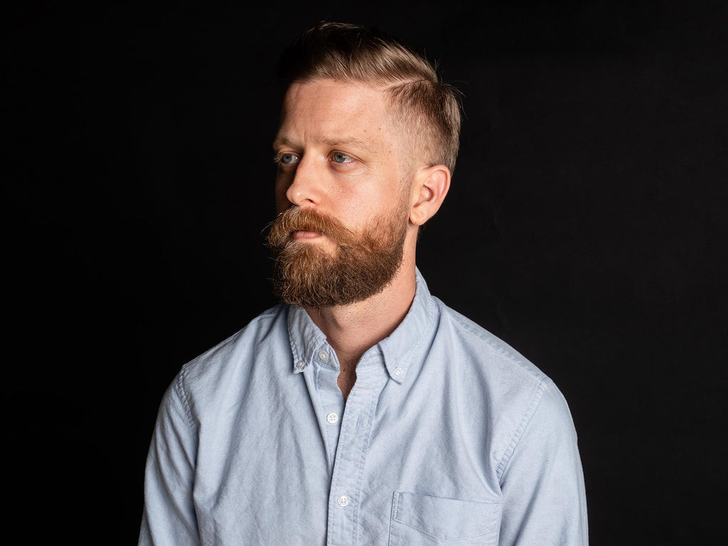 Blonde man with a blonde faded beard, exemplifying a modern and stylish appearance.