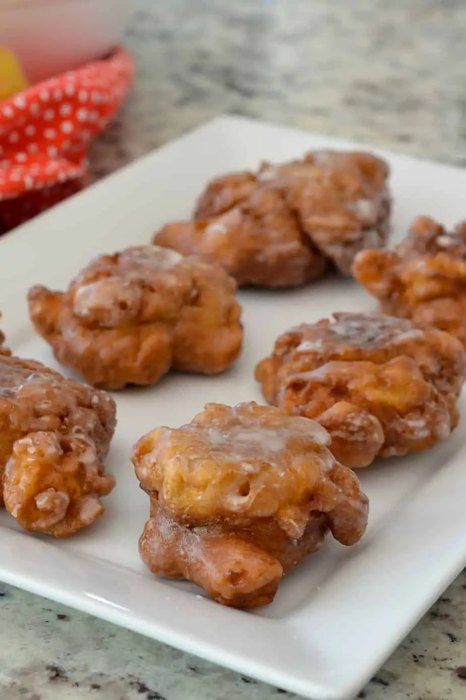 A close-up of a homemade apple fritter, showcasing the apple pieces and cinnamon, with a focus on healthier ingredient options.