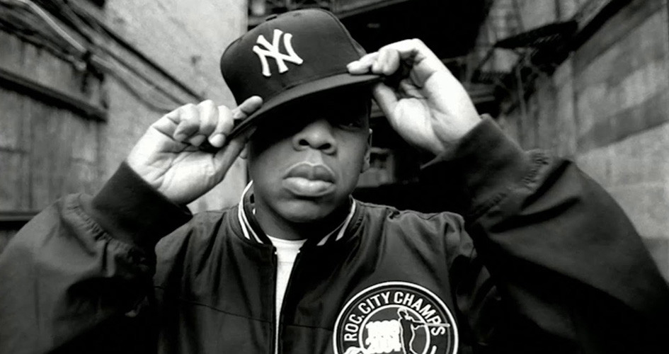 Jay-Z in 2000s hip-hop style, wearing a Roc-A-Fella chain and a fitted cap