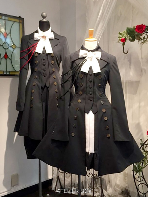 Two mannequins dressed in Atelier BOZ Roland Jacket outfits, one in a masculine style and one in a feminine style, embodying the brand's classical and elegant attire reminiscent of medieval Europe.