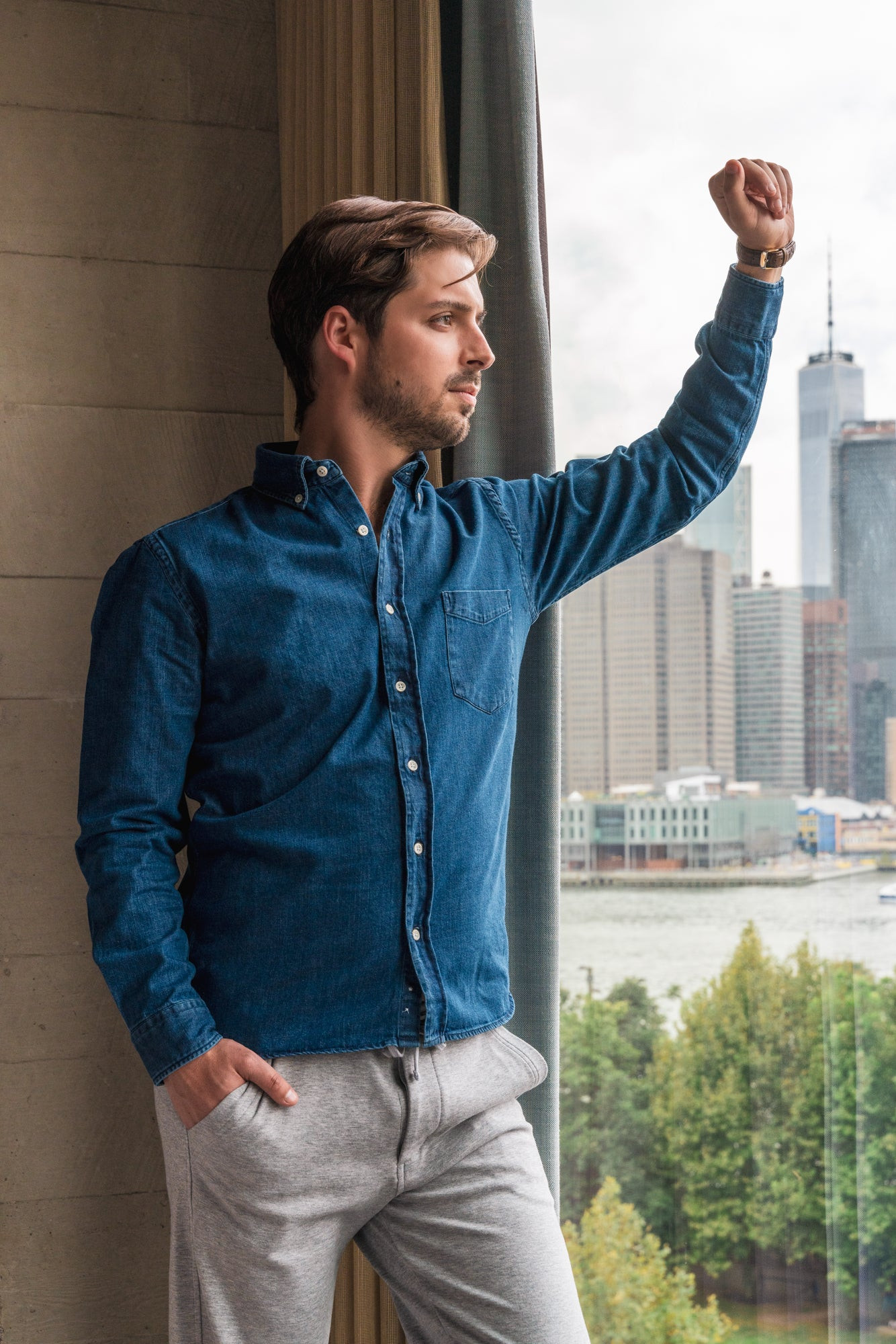 Short chubby guy wearing gray henley, navy chinos, and white sneakers