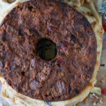Fruitcake being unwrapped after soaking in brandy