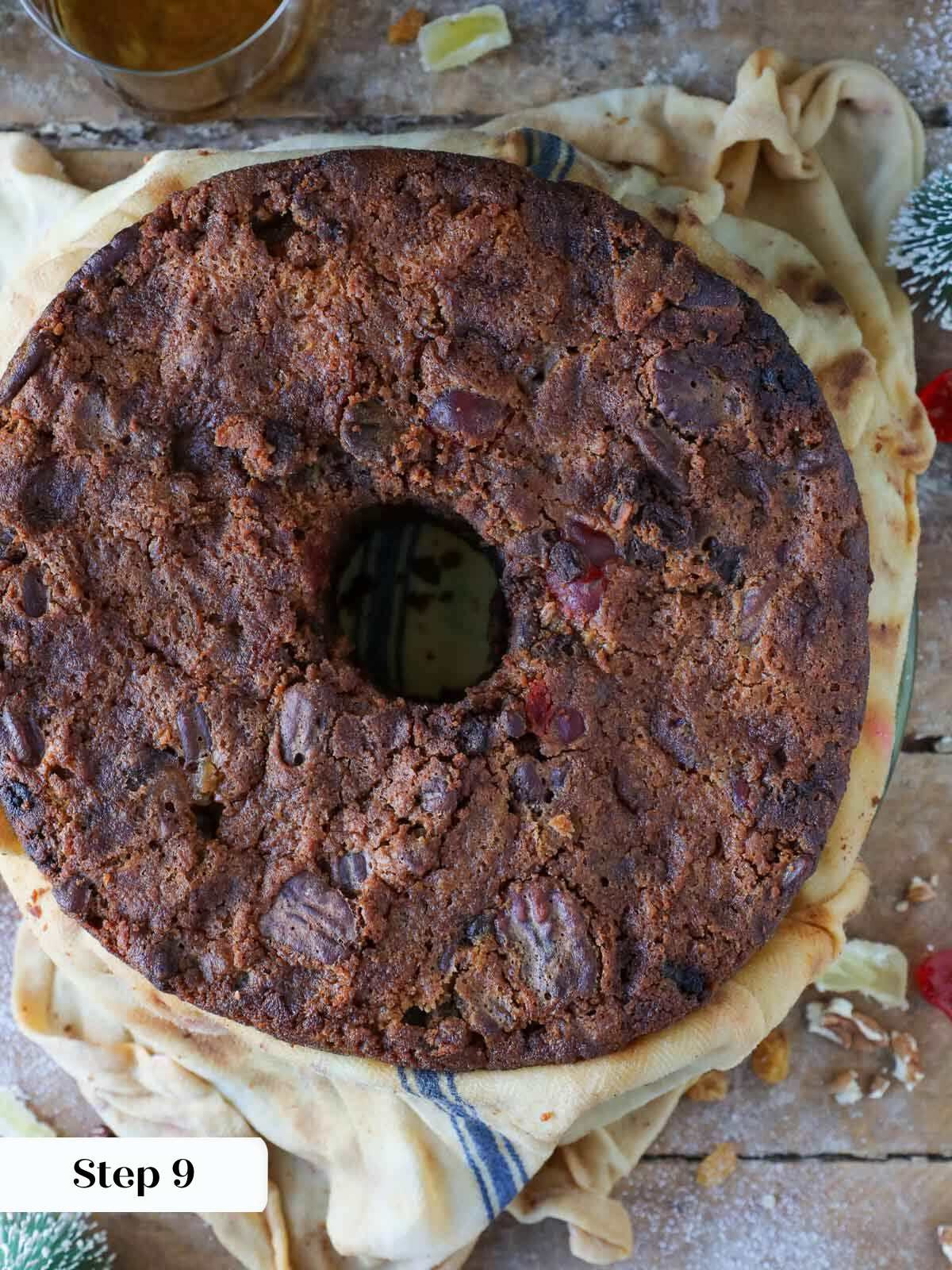 Fruitcake being unwrapped after soaking in brandy