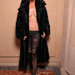 Katy Perry at Balenciaga Fall 2024 Couture, showcasing an oversized black coat with striking design elements.