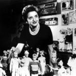 Ruth Handler poses with a group of Barbies
