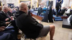 John Fetterman wearing shorts and a hoodie at the inauguration, a bold fashion statement defying traditional norms.