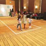 Boys in stylish outfits at Juniors Fashion Week, showcasing the latest trends in teen fashion.