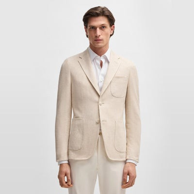 alt text: Stylish man in a modern suit outside Apple store at Fashion Mall Keystone