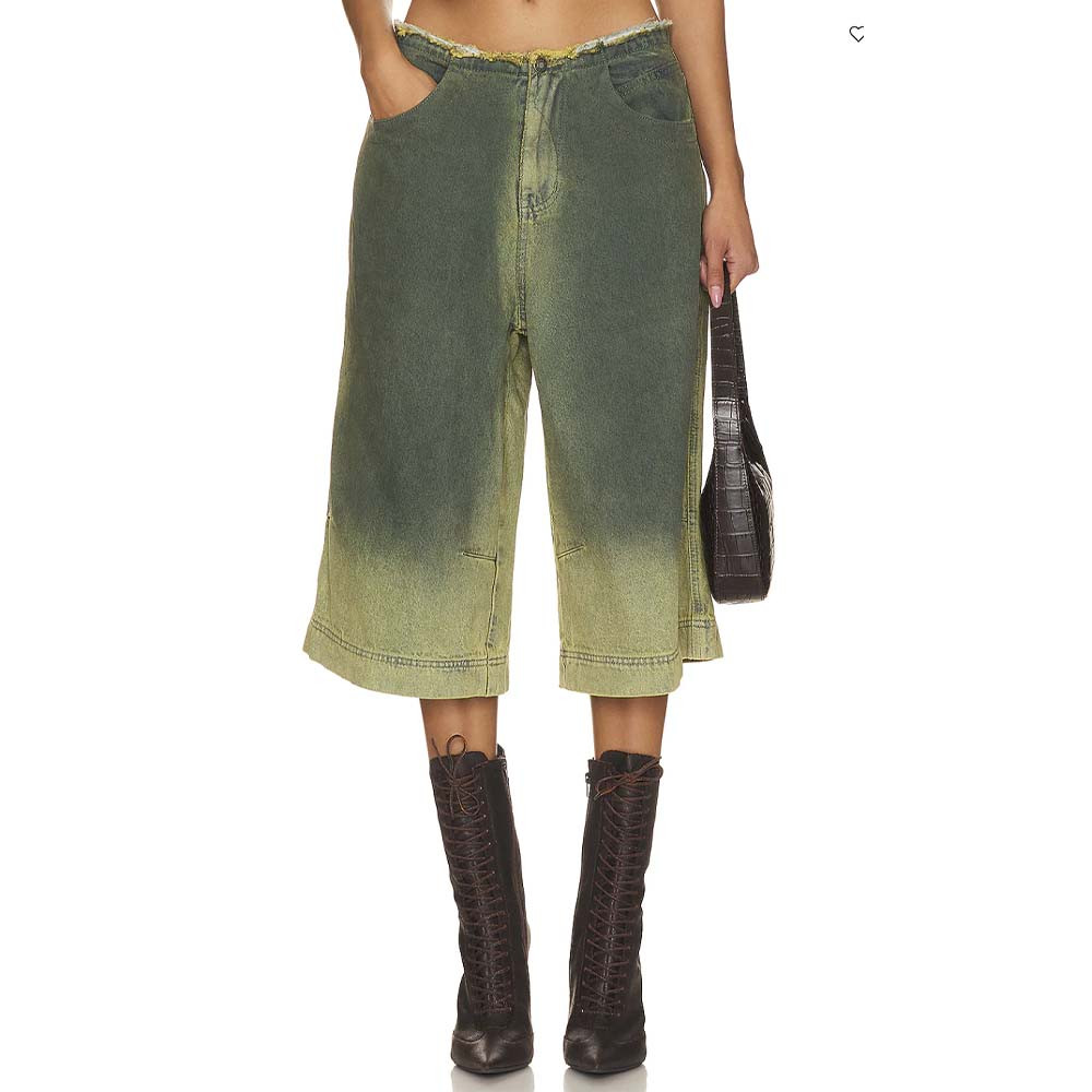 Model wearing denim jorts and brown boots for brat summer fashion