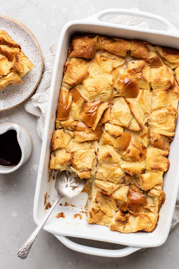 Finished bread pudding in a 9x13 pan, served with syrup.