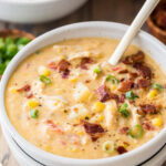 Bowl of chicken corn chowder topped with bacon and green onions