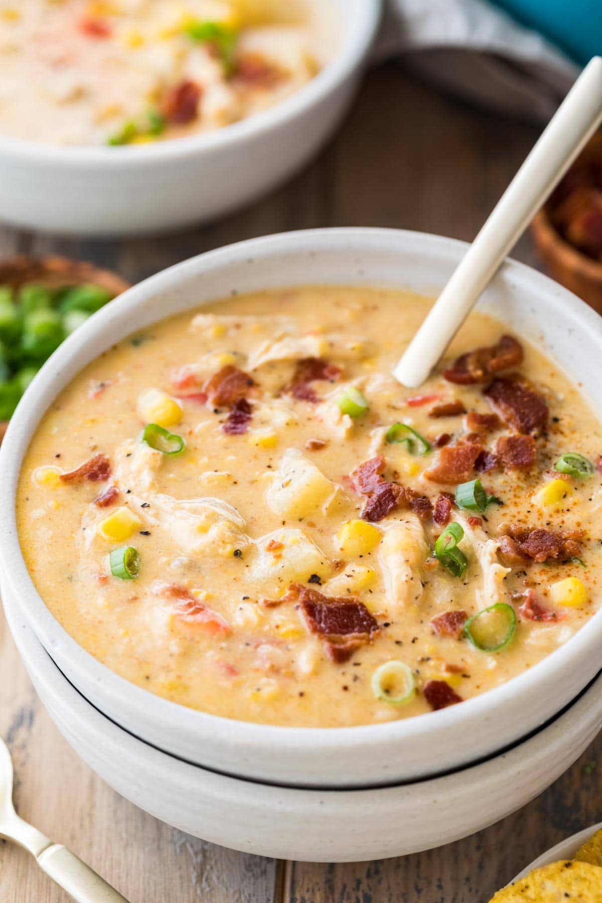 Bowl of chicken corn chowder topped with bacon and green onions