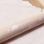 Dumpling dough rolled flat on a floured surface