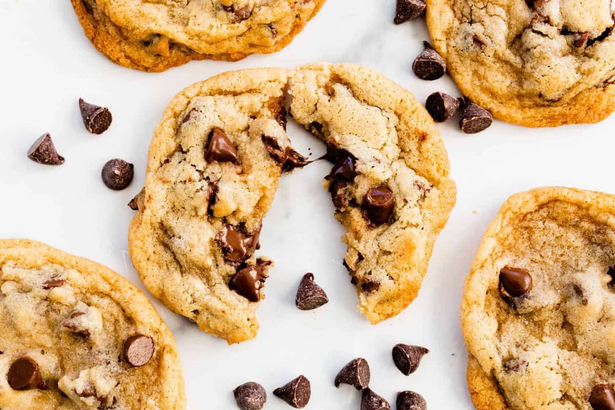 An assortment of old fashioned cookies displayed on a rustic wooden table, emphasizing their simple ingredients and homestyle appeal.