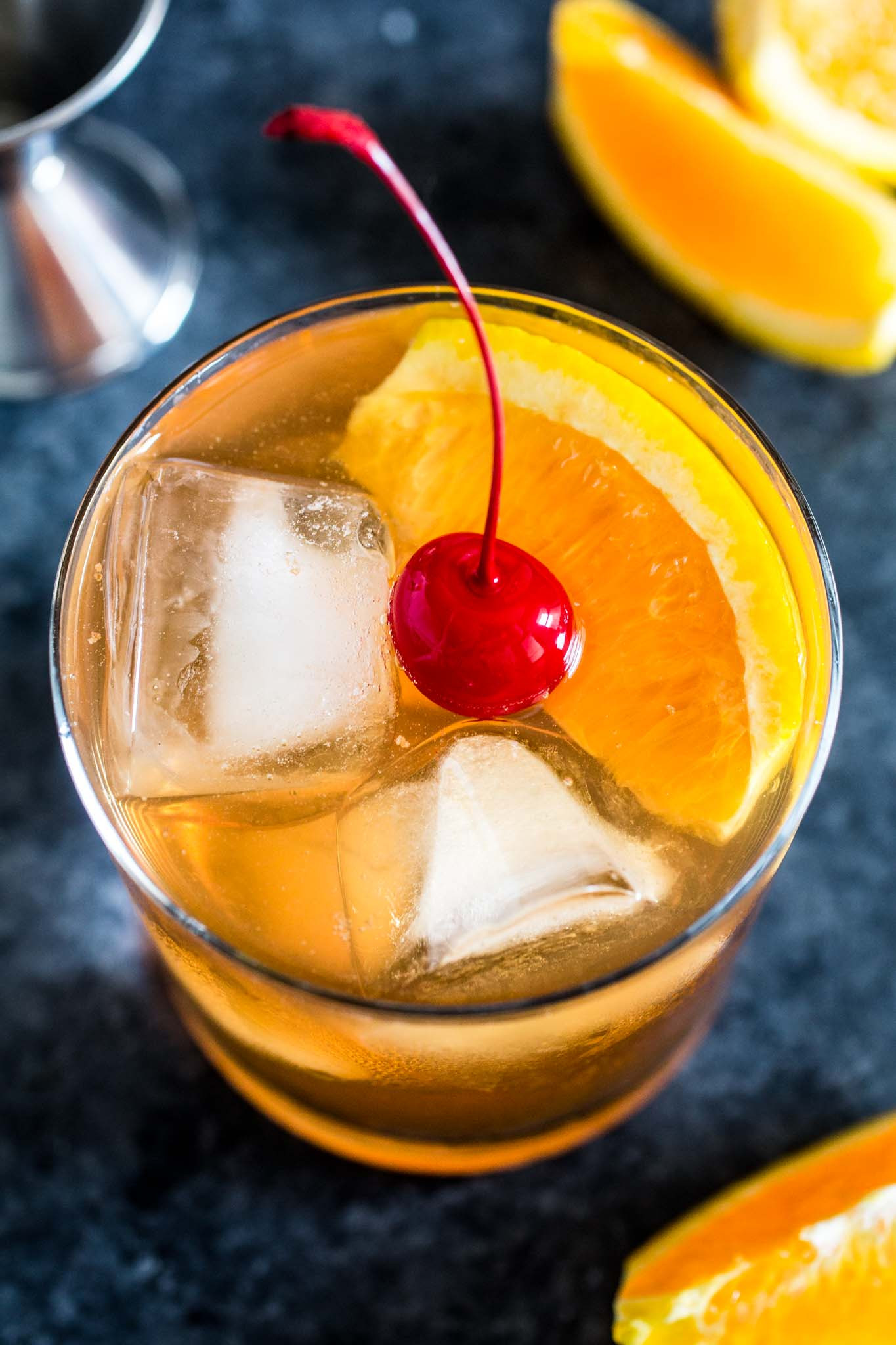 Classic Old Fashioned cocktail served in a traditional rocks glass, garnished with an orange peel and a maraschino cherry, highlighting the perfect presentation for this timeless drink