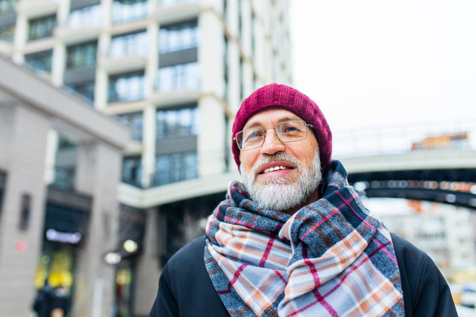 Bearded man wearing a stylish blue scarf outdoors