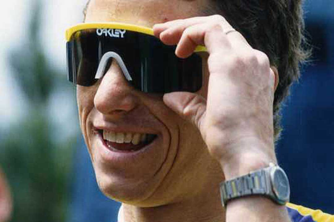 Cyclist wearing yellow rimmed 80s style sunglasses