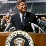 JFK in a slim-fitting suit, showcasing his classic and modern style.