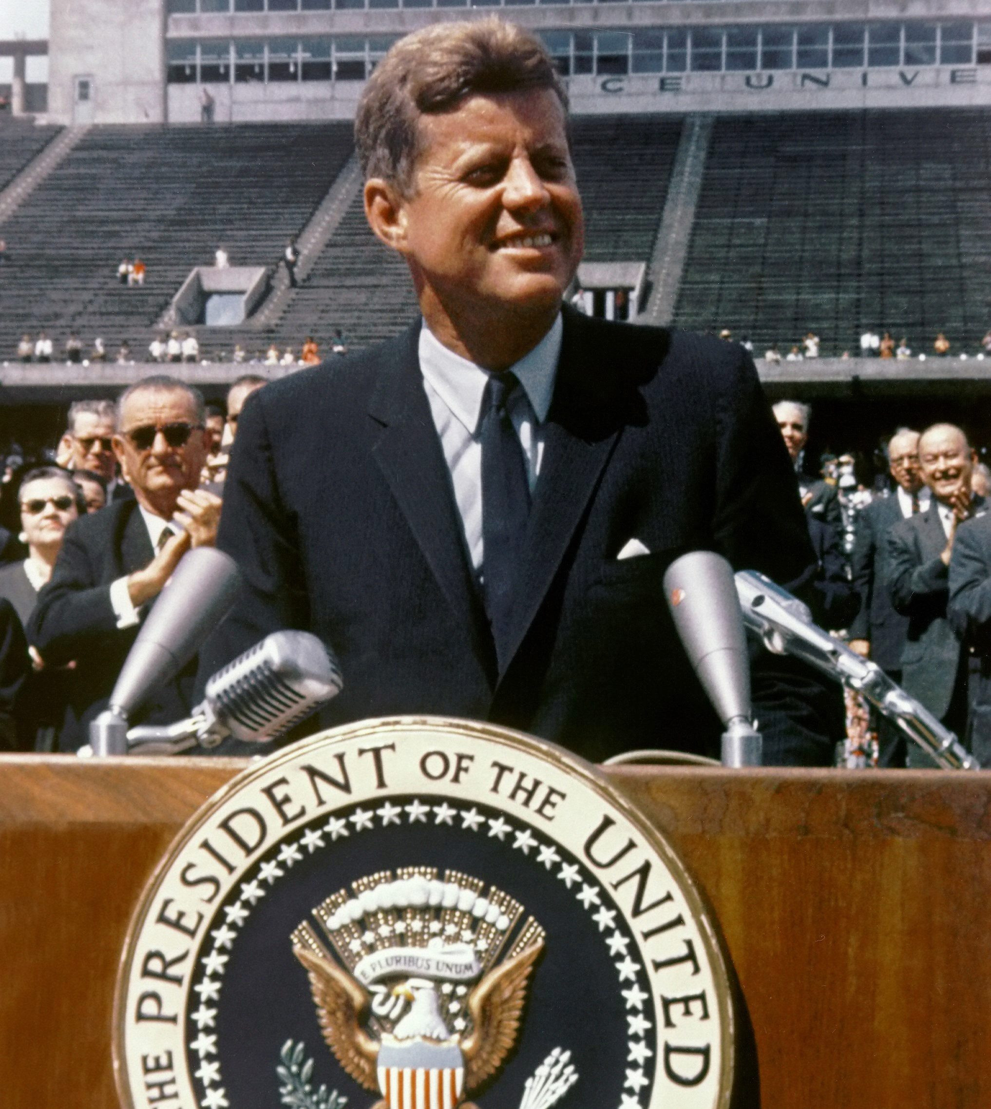 JFK in a slim-fitting suit, showcasing his classic and modern style.