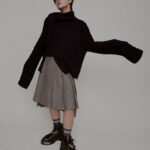 Zhou Zennan wearing a skirt for ELLE China, showcasing the influence of gender fluidity in Chinese men's fashion, a trend explored further on mens-fashion.net