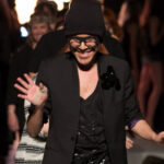 Fashion designer Mondo Guerra walks down the runway with his 2014 Denver Fashion Week collection