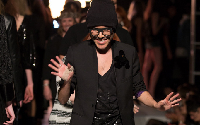 Fashion designer Mondo Guerra walks down the runway with his 2014 Denver Fashion Week collection
