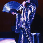 Harry Styles in a sequined suit, showcasing modern disco fashion