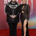 Jelly Roll and Bunnie DeFord attend the 60th Academy of Country Music Awards, showcasing contrasting yet complementary styles with Jelly Roll in a modern take on classic pieces and Bunnie DeFord in a striking, bold outfit