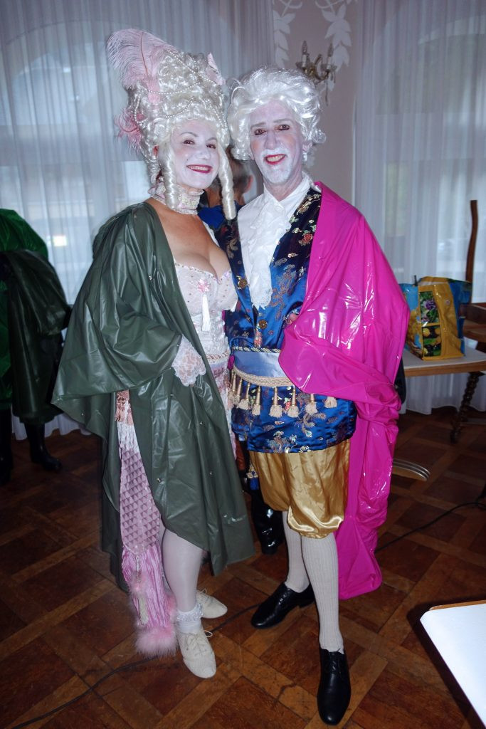Two people with creative and individual clothing style looking at each other in a friendly way