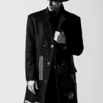 Man standing in a classic front-facing pose, showcasing his stylish outfit with confidence